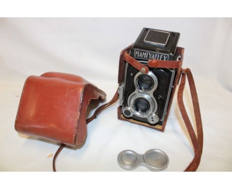 A Mamiyaflex twin lens reflex camera in leather case