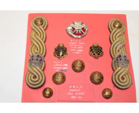 A display of DCLI Officers badges and insignia including silver DCLI cap badge, hallmark 1899, pair of Officers enamelled col