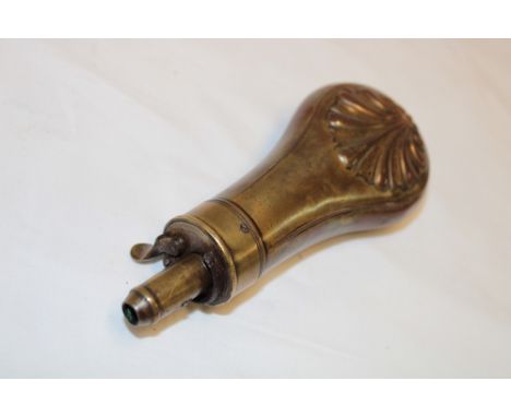 A 19th century brass mounted copper pistol powder flask with raised acanthus decoration 5" long