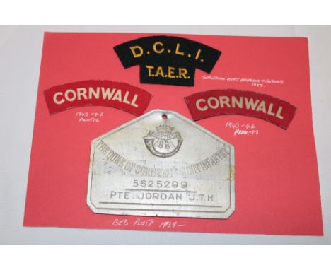 A Duke of Cornwall's Light Infantry zinc duty bed plate named to No. 5625299 Pte. J. T. H. Jordan together with three shoulde