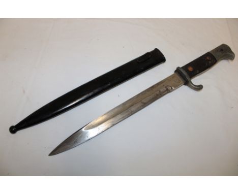 A Second War German bayonet by Luneschloss of Solingen with chequered composition grip in steel scabbard