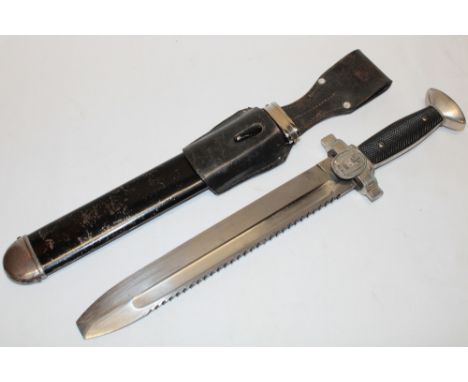 A Second War German Red Cross dagger, 10½" single edged saw-back blade marked "GES Geschutzt" with traditional plated hilt in