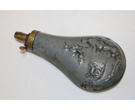 A 19th century zinc and brass mounted powder flask decorated in relief with a hunter and dog