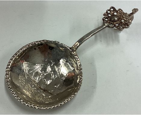 A 19th Century Continental silver caddy spoon embossed with yacht decoration to bowl. Approx. 22 grams. Est. £30 - £40.