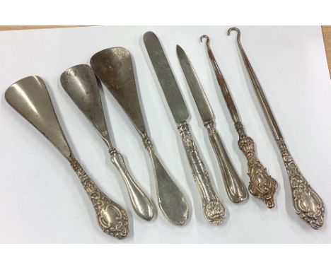 A large collection of silver mounted button hooks and shoe horns. Approx. 248 grams. Est. £30 - £50.
