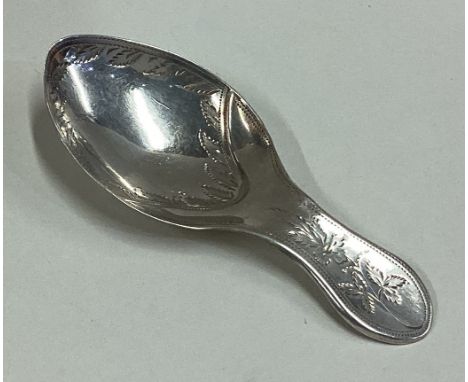 A George III silver caddy spoon with bright-cut decoration. Birmingham 1804. Approx. 8 grams. Est. £40 - £60.