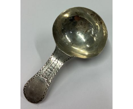 A Georgian silver caddy spoon with bright-cut decoration to terminal. London 1827. Approx. 11 grams. Est. £30 - £40.