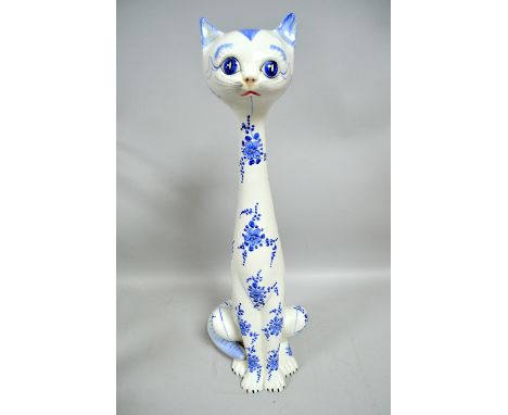 Large model of a ceramic cat together with a wood carving of an antelope and other various mid century ceramics and wares.