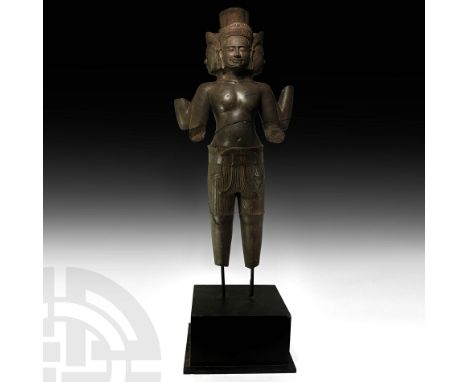 11th-13th century AD. A large polished Khmer red sandstone statue of Brahma standing with his four arms bent; the four radiat