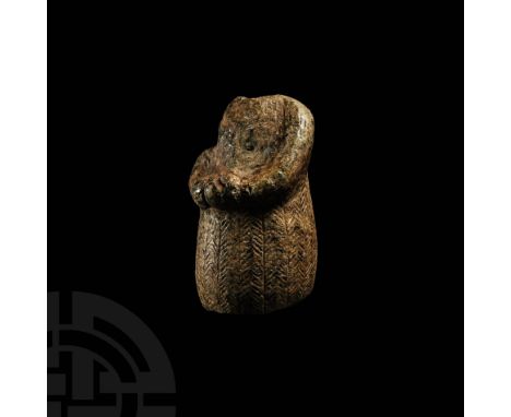 3rd-early 2nd millennium BC. A chlorite figure modelled as a female standing wearing a floor-length robe with incised herring