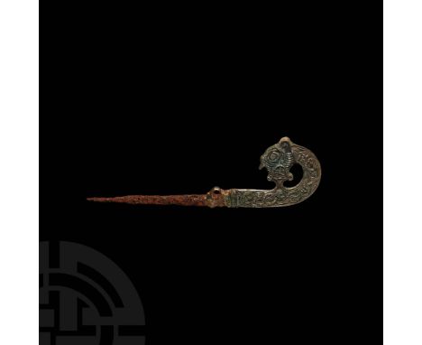 9th century AD. An iron spike or pin with silver head comprising a flared panel with loop to accept a chain and lattice ornam