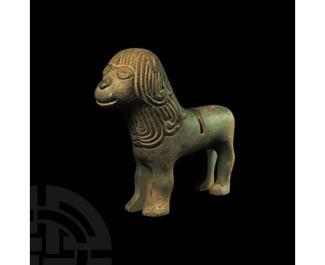 Late 11th-12th century AD. A substantial bronze lion probably from the base of a lamp or pricket candlestick, the body modell