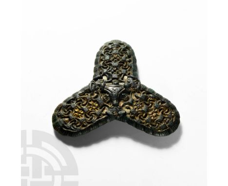 9th century AD. A superb gilt-bronze trefoil brooch with alternating hatched and plain segments to the rim, dense inner patte