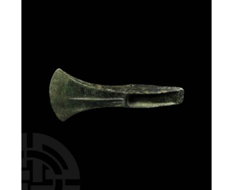 15th-10th century BC. A bifacial bronze palstave axe head with tapering lentoid-section body, fanning out to a D-section blad