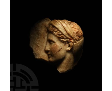 4th century BC. A carved marble frieze fragment depicting the head of Aphrodite or a muse modelled in the half-round with det