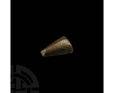 9th-10th century AD. A bronze animal-head brooch, trapezoidal in plan with triangular panels to the edges of the broader end,