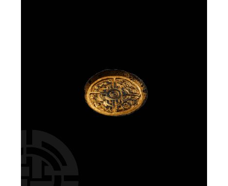 6th century AD. A gilt-bronze saucer brooch with everted flange rim, four quadrant panels and central concentric rings; two q