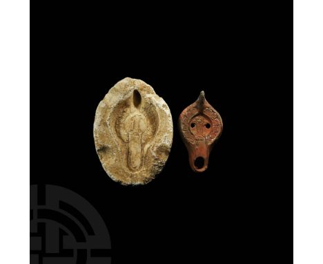 4th-6th century AD. A redware lamp with squat D-section body, D-shaped nozzle, two filling holes to the discus, raised column