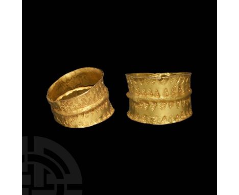 10th-12th century AD. A broad gold finger ring with flared rims and median rib, two bands of opposed punchmarks, each a trian