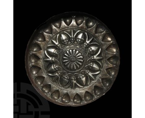 8th-5th century BC. A large sheet-silver phiale with squat D-section wall and everted rim, decorated using repoussé technique