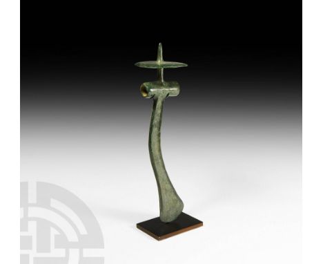 Mid 16th-mid 13th century BC. A bronze axehead comprising a tubular socket with external facets, a slender, curved blade with