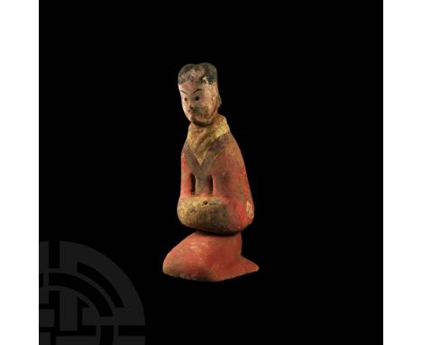 Han Dynasty, 206 BC-220 AD. A polychrome terracotta figure modelled in the round as a kneeling servant, wearing a long robe, 