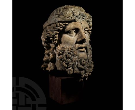1st-2nd century AD. An over life-size composition head of a frowning elderly male with a thick beard; broad facial features w
