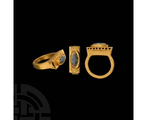 4th-6th century AD. A gold ring with rectangular-section hoop, rectangular bezel with openwork sides, u-section at the shorte