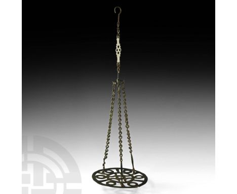 6th-7th century AD. A bronze discoid polycandelon, or hanging lamp holder, with stylised central openwork Christian cross sur
