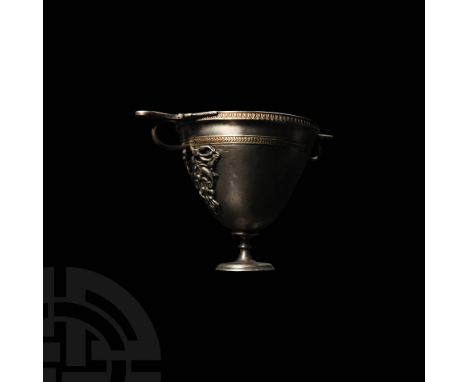 1st century BC-1st century AD. A two-handled cup with the body raised from a single sheet of silver resting on a flared foot,