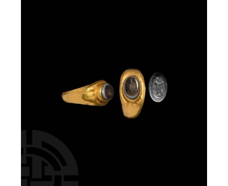 1st-2nd century AD. A gold finger ring with ellipsoid cell to the bezel, inset onyx gemstone with intaglio figure of Mercury 