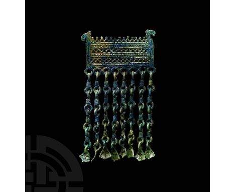 10th-12th century AD. A bronze pendant with openwork rectangular body with stylised horse head terminals, horizontal rows of 