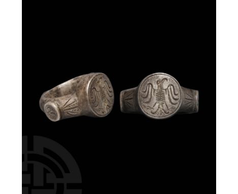 Eastern European, 15th century AD. A substantial silver finger ring with D-section hoop, knop to the underside, lateral disc 