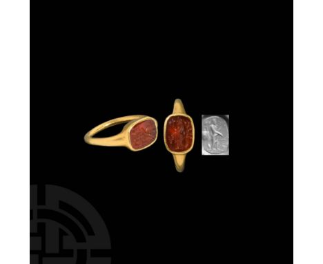 c.1st century AD. A gold ring with round-section hoop and rectangular bezel with rounded corners, set with a carnelian intagl