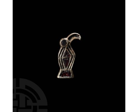 Later 5th-6th century AD. A silver-gilt plate brooch of a stylised bird with lozengiform body; a cell to the hooked beak, dis