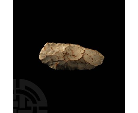 Mesolithic, 15000-7000 BP. A knapped bifacial axe with convex cutting edge tapering to slightly pointed butt; in a creamy, of
