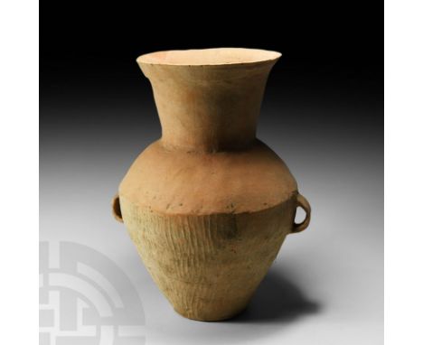 c.2nd millennium BC. A terracotta jar with piriform body, broad splayed neck and rim and rectangular-section loop handles, ve