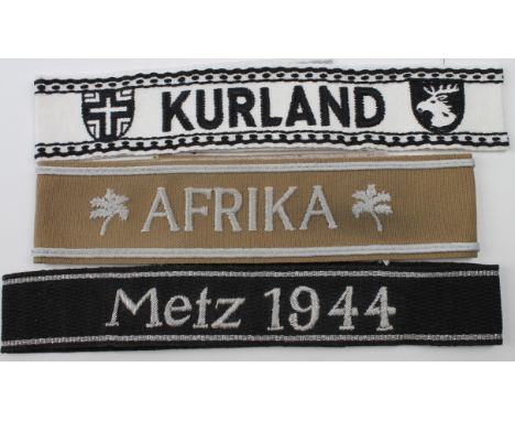 German WW2 cuff titles for 'Afrika', 'Metz 1944' bullion wire, and Kurland'.   (3)