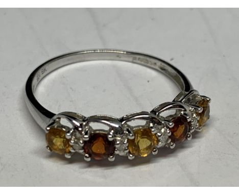 A 9 CARAT GOLD RING WITH CITRINES, RED GARNETS AND DIAMONDS SIZE T 
