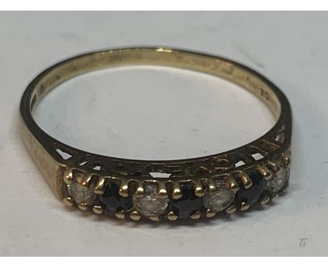 A 9 CARAT GOLD RING WITH THREE SAPPHIRES AND FOUR CUBIC ZIRCONIAS IN A LINE SIZE L/M 
