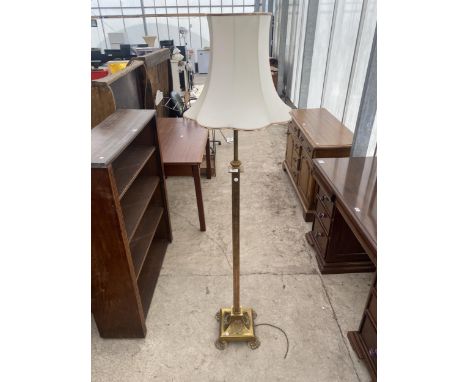 AN ADJUSTABLE BRASS STANDARD LAMP ON SQUARE BASE, WITH CLAW FEET, COMPLETE WITH SHADE 