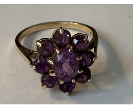 A 9 CARAT GOLD RING WITH NINE AMETHYSTS IN A FLOWER DESIGN  SIZE Q/R GROSS WEIGHT 3.59 GRAMS 