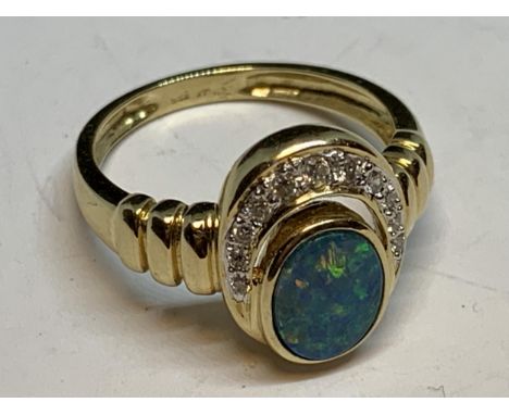 A 14 CARAT GOLD RING WITH A CENTRE OPAL SURROUNDED BY DIAMONDS GROSS WEIGHT 3.84 GRAMS SIZE M/N WITH A PRESENTATION BOX 