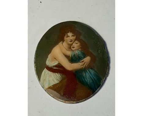 AN ENAMEL DISC OF A MOTHER AND CHILD 