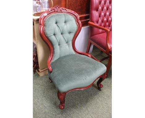 Upholstered Spoon back button back saloon chair on brass casters 