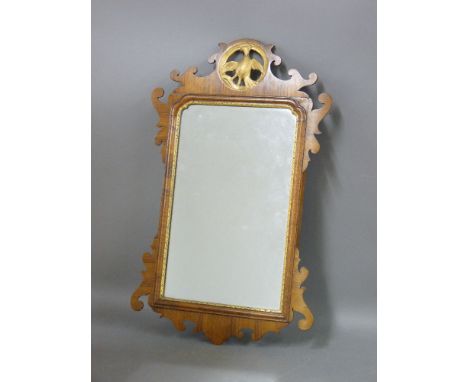 A walnut and parcel gilt wall mirror, the top surrounded with a pierced panel with a ho-ho bird
