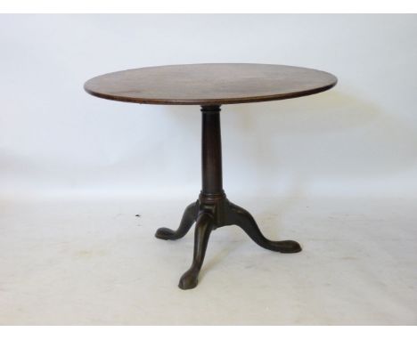 An 18th century mahogany tripod table, the gun barrel column above three cabriole legs