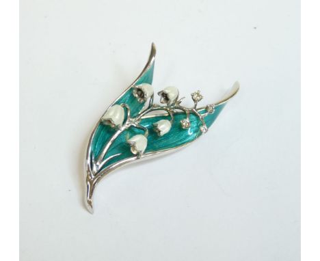 A sterling silver and enamel lily of the valley brooch, with moving flower heads and diamond set buds