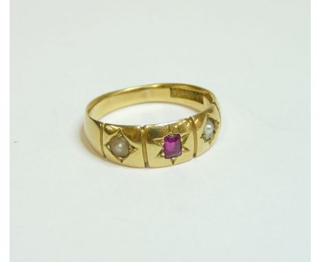 A three stone ruby and split pearl star set gypsy ring, marked 18ct, finger size N½