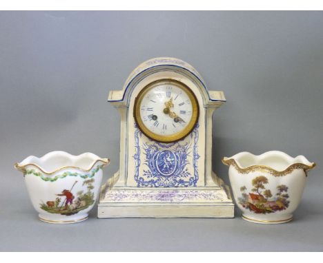 A pottery mantel clock, with blue printed decoration, 27cm high, and a pair of cachepots with printed decoration in the Meiss